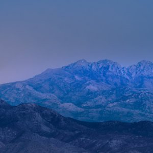 Blue-toned full moon rising over Four Peaks in the Sonoran Desert near Scottsdale, Arizona.
