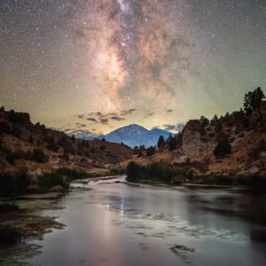 Astrophotography of the Milky Way reflecting in the geothermal waters of Hot Creek in California's Eastern Sierra.