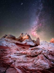 White Pocket Arizona astrophotography with the Milky Way and Cygnus region over swirling sandstone rock formations.